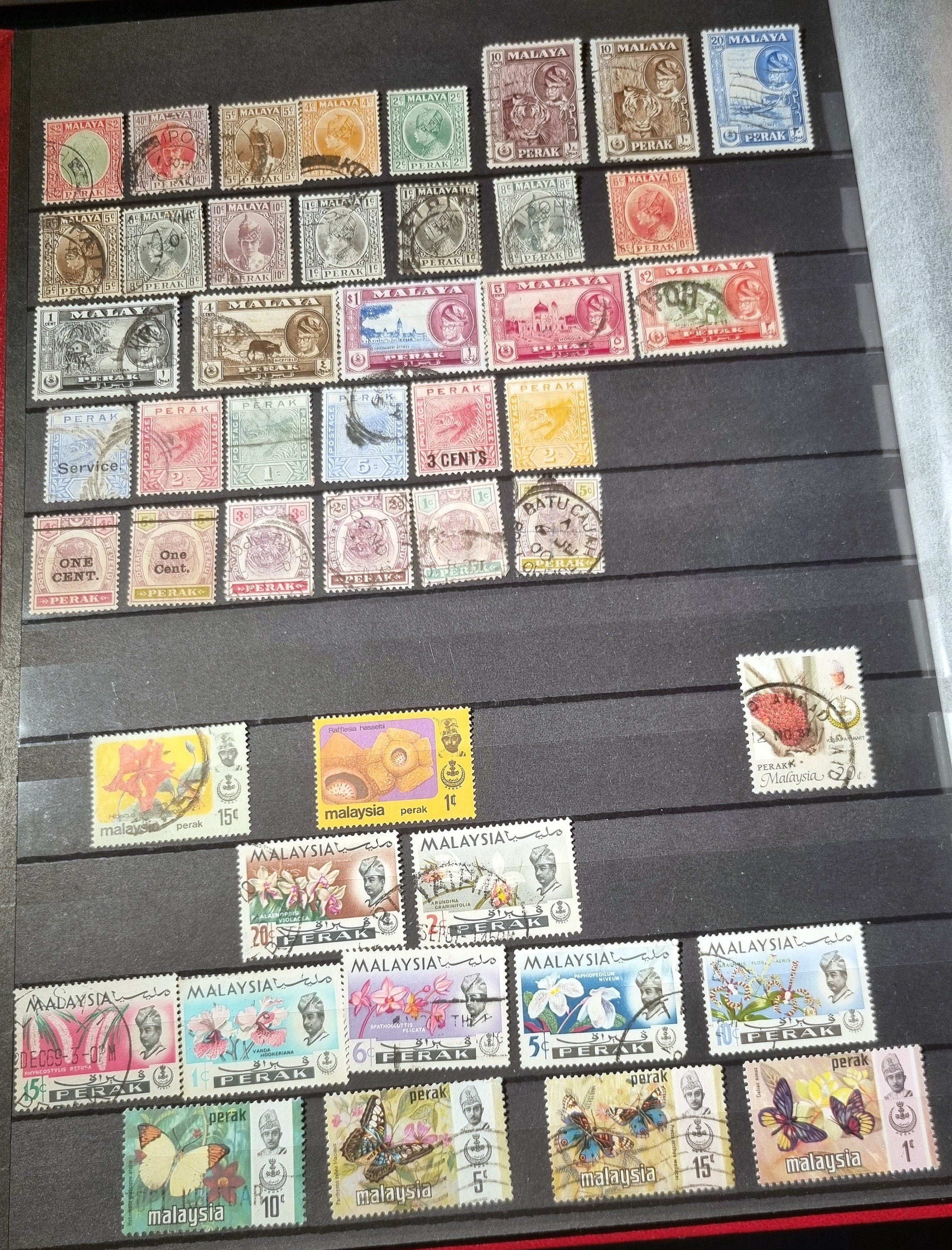 A collection of various vintage Malay state stamps