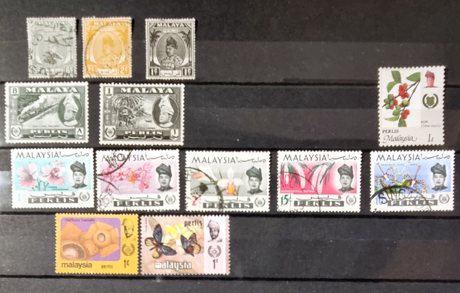 A collection of various vintage Malay state stamps