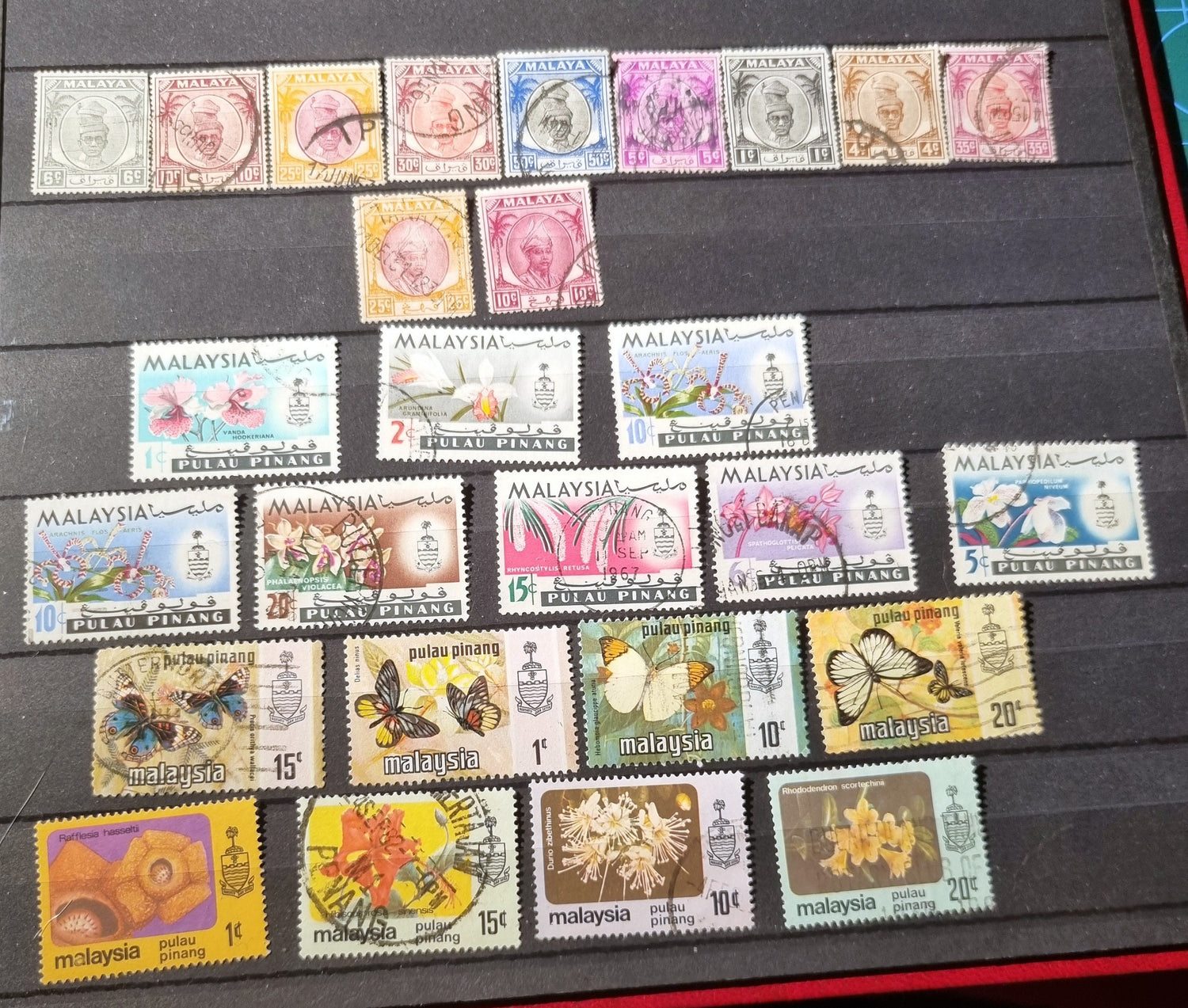A collection of various vintage Malay state stamps