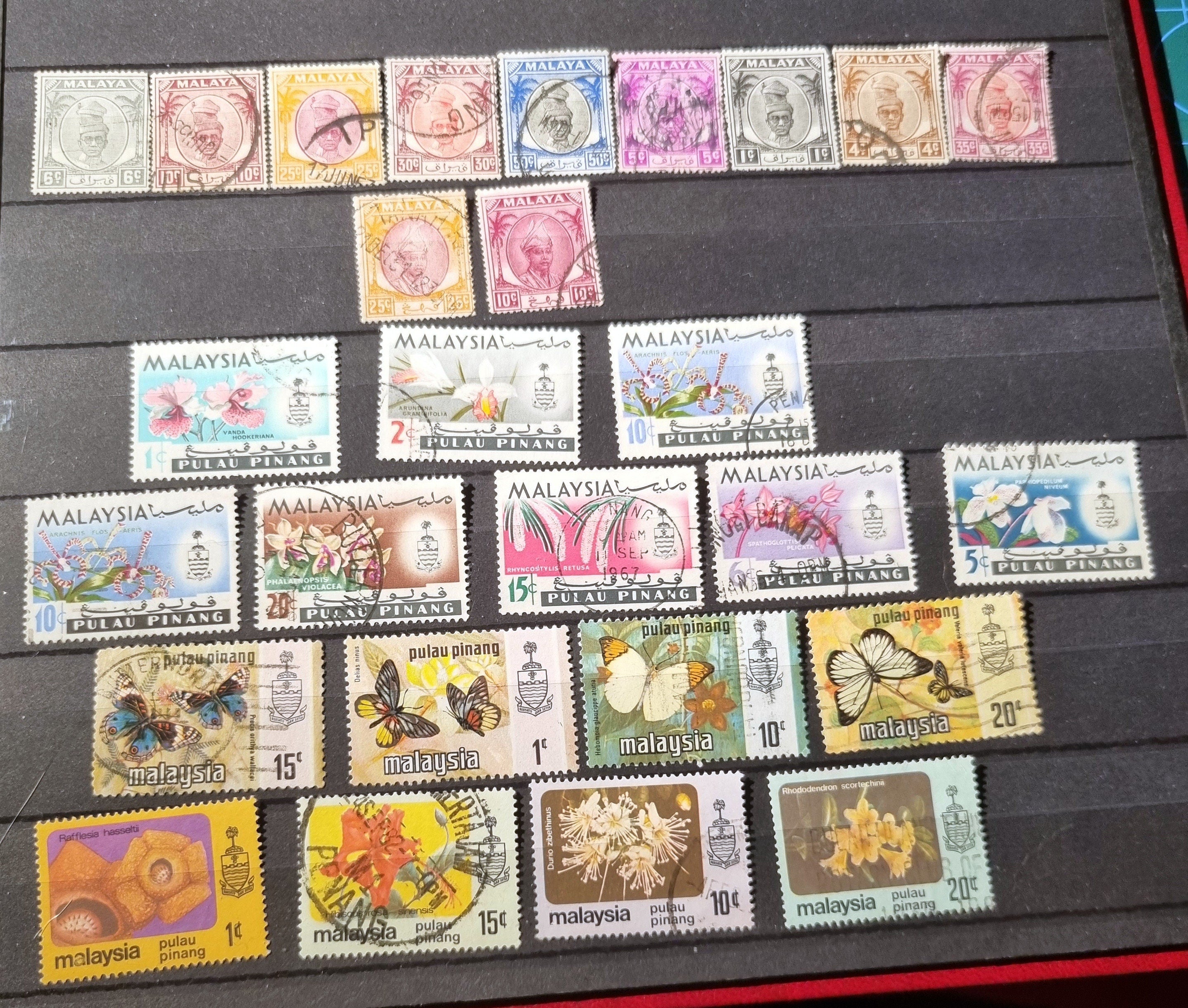 A collection of various vintage Malay state stamps