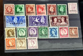 A collection of various vintage Tangier postage stamps displayed on a surface, with different colors and designs, including portraits of a king and a queen.