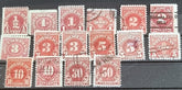 A collection of vintage red US postage due stamps with various denominations.