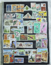 A collection of various postage stamps featuring different designs and colors, arranged in no specific order on a black background.