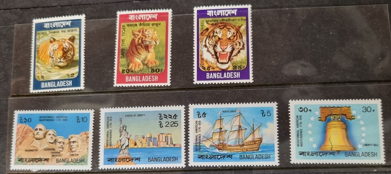A set of vintage Bangladesh postage stamps displayed in a row, showcasing various designs including portraits and images of animals and flowers.