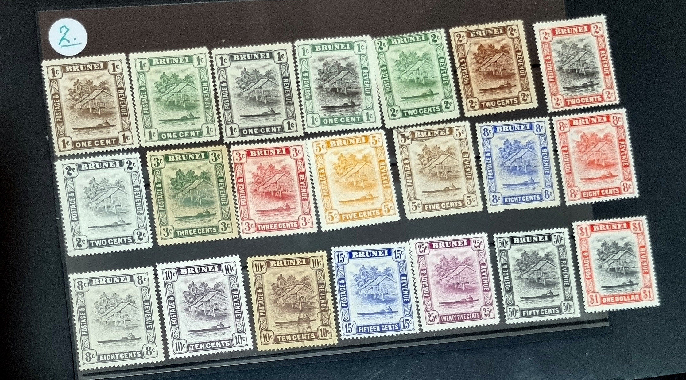 A collection of various vintage Brunei postage stamps displayed in a row, with different colors and designs representing different themes.