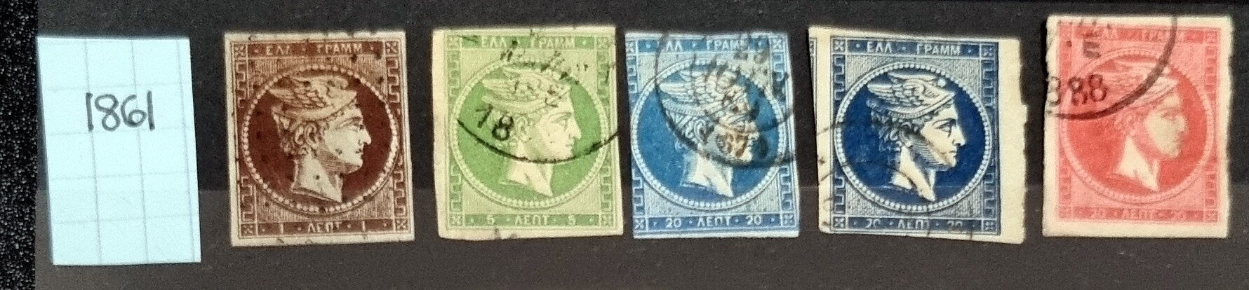 A collection of vintage Greek stamps, featuring different designs and colors, arranged side by side.
