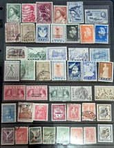 A collection of vintage Greek stamps, featuring different designs and colors, arranged side by side.