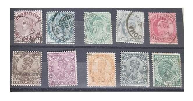 A collection of various Indian postage stamps displayed in a row, showcasing different colors and designs.