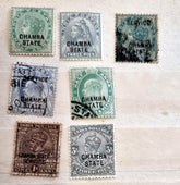 A collection of various Indian postage stamps displayed in a row, showcasing different colors and designs.