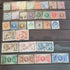 A collection of various vintage postage stamps featuring portraits of King George V, with a focus on stamps from the 1920s and 1930s.