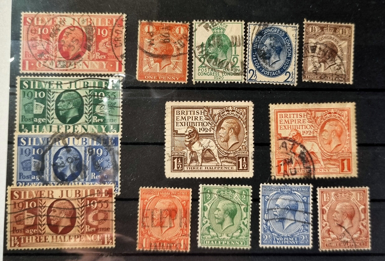 A collection of various vintage postage stamps featuring portraits of King George V, with a focus on stamps from the 1920s and 1930s.