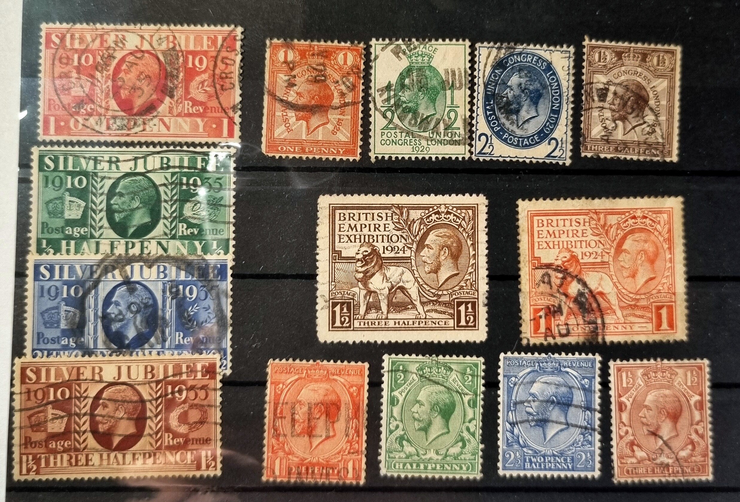 A collection of various vintage postage stamps featuring portraits of King George V, with a focus on stamps from the 1920s and 1930s.