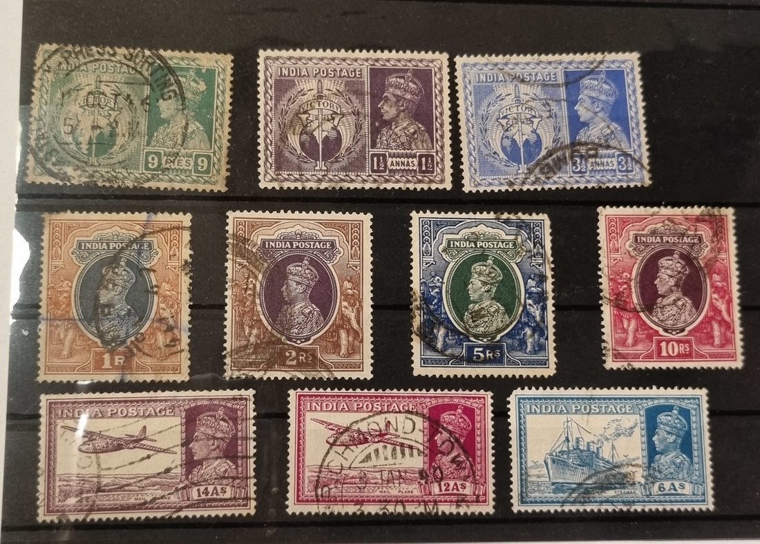 A collection of vintage Indian postage stamps featuring portraits of King George VI, with various colors and designs.