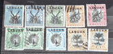 A collection of six vintage Labuan postage stamps with various designs, predominantly in green, blue, and brown shades, featuring inscription &