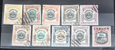 A collection of six vintage Labuan postage stamps with various designs, predominantly in green, blue, and brown shades, featuring inscription &