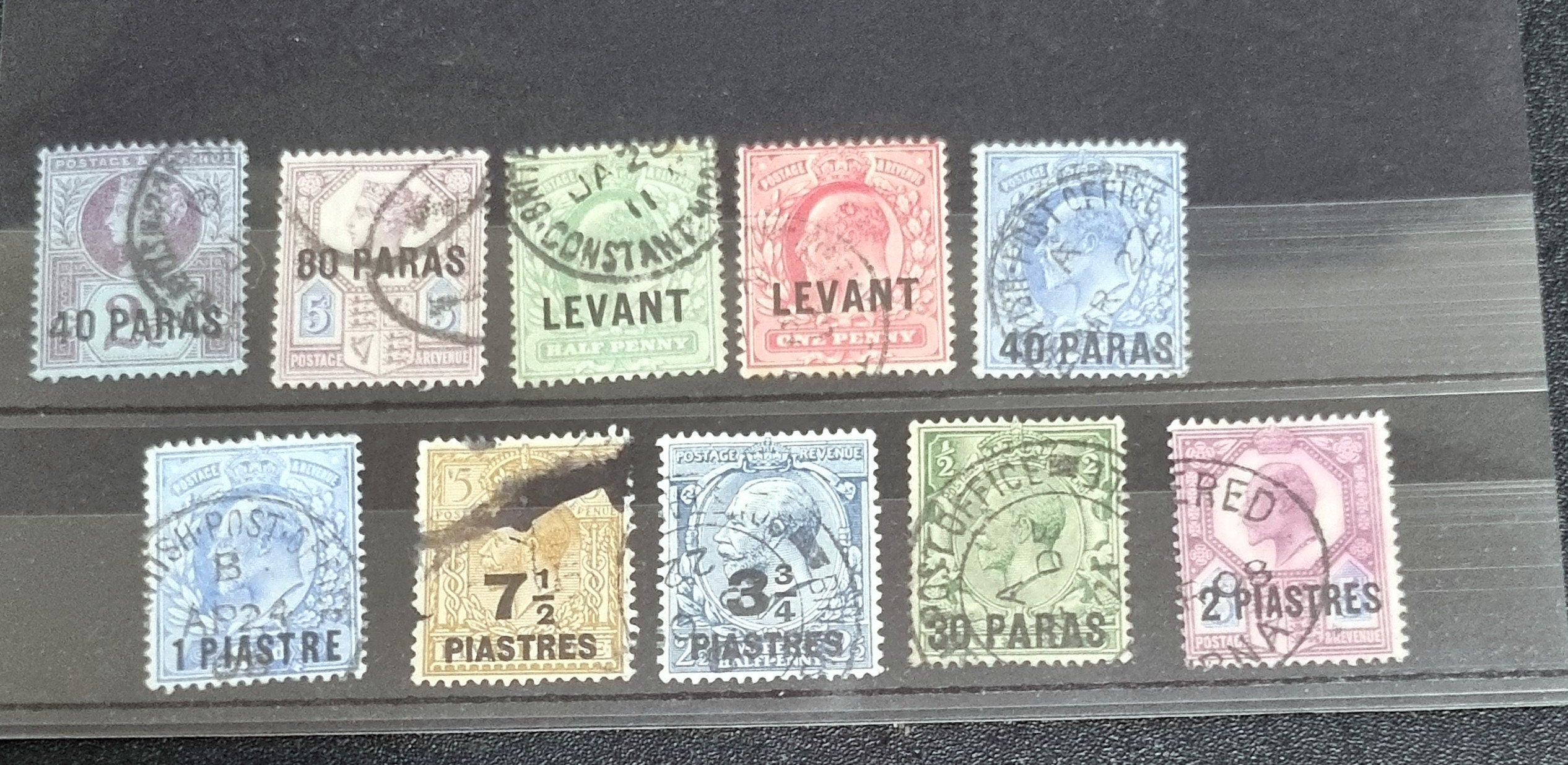 A collection of vintage postage stamps from the Levant, featuring various colors and designs, some with post marks.