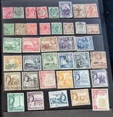 A collection of vintage postage stamps from Malta featuring various designs and colors, arranged in no specific order on a surface.