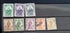 A collection of vintage postage stamps from Malta featuring various designs and colors, arranged in no specific order on a surface.
