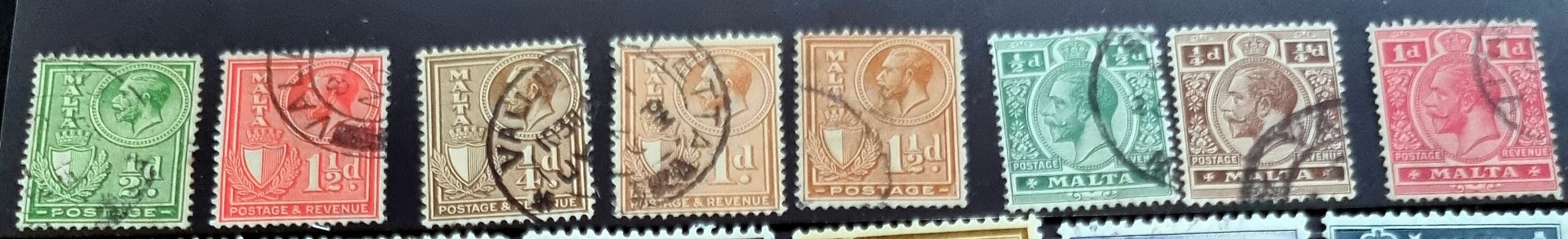 A collection of vintage postage stamps from Malta featuring various designs and colors, arranged in no specific order on a surface.