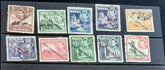 A collection of vintage postage stamps from Malta featuring various designs and colors, arranged in no specific order on a surface.
