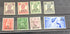 A collection of various denominations of British Post Office stamps from Muscat, Oman, laid out on a flat surface.