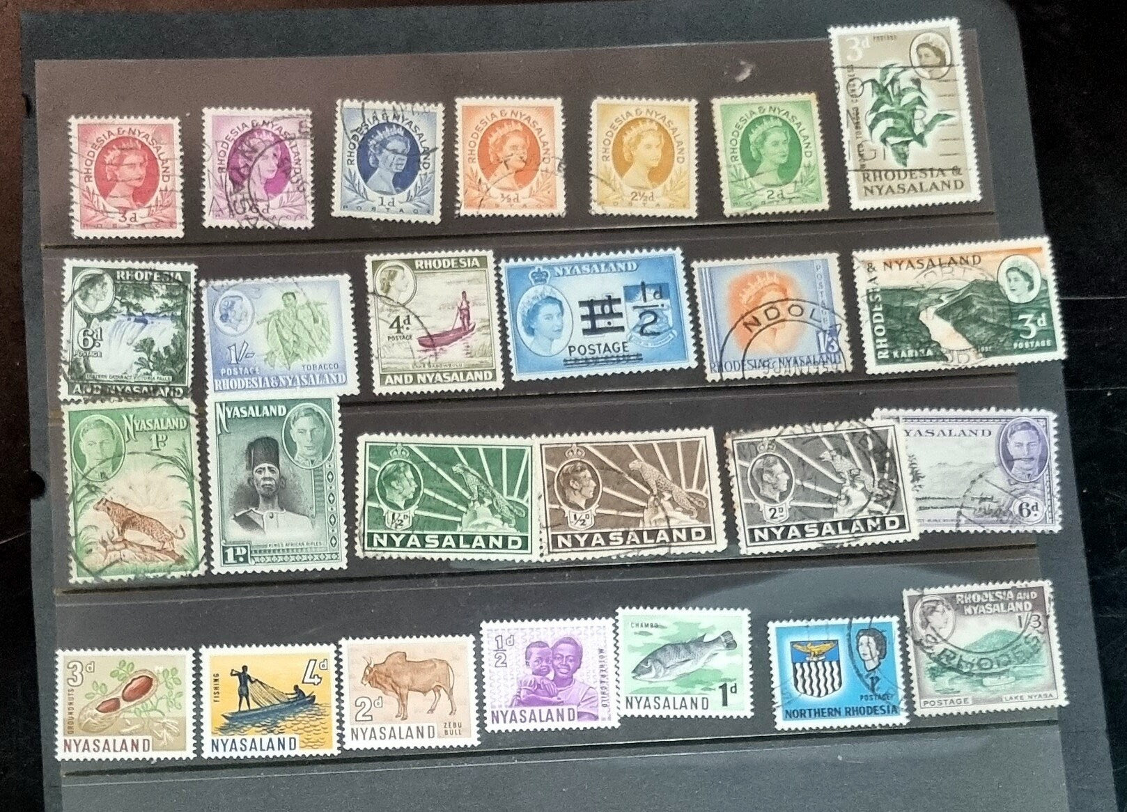 A collection of Nyasaland vintage stamps displaying various images and text, arranged in a row.