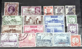 A collection of vintage Pakistan stamps from various periods, showing different designs and denominations, displayed on a glass surface.