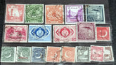 A collection of vintage Pakistan stamps from various periods, showing different designs and denominations, displayed on a glass surface.
