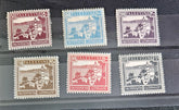 A collection of vintage Palestine postage stamps from 1918-1921 with various designs and colors, displayed in a row.