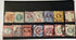 A collection of vintage Queen Victoria Jubilee stamps, displayed in a row, varying in color and design, set against a black background.