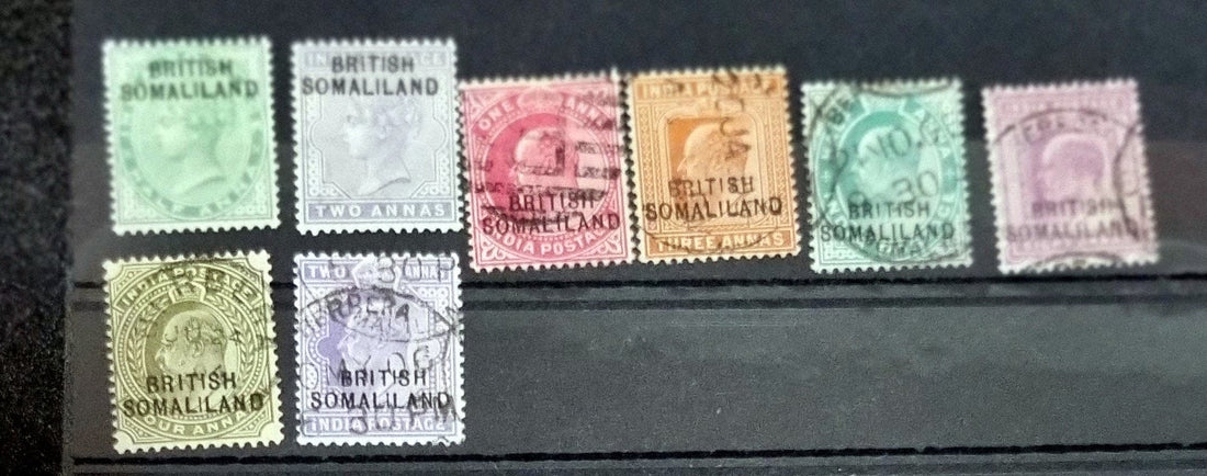 A collection of vintage Somaliland stamps displaying various national emblems and monetary denominations, arranged on a dark background.