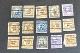 A collection of vintage USA postage stamps with various overprints and cancellations.
