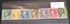 A collection of vintage US postage stamps featuring images of George Washington and Abraham Lincoln, among others, displayed in a case.